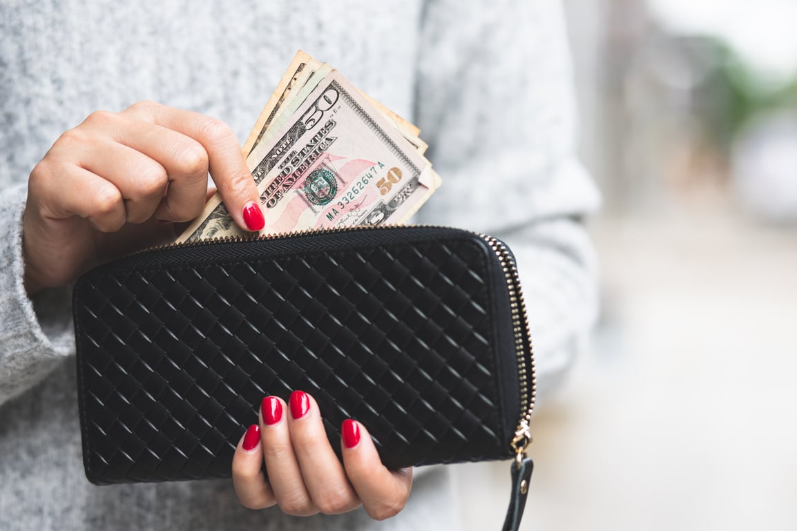 Woman Getting Money from Wallet
